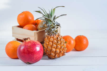 Group of fresh tropical fruits in small wooden box.の写真素材