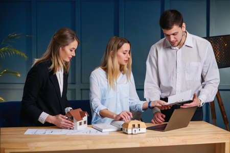 Group of architects, designer working on the project of new house, flat.