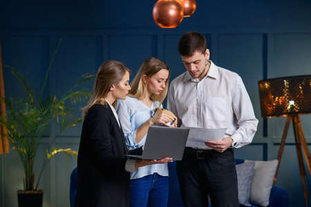 Pretty young couple on the meeting with realtor in the office.