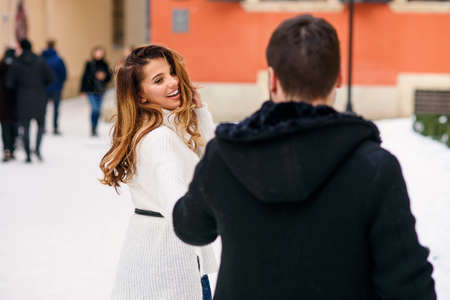 young loving couple on natural winter background. New Year and Christmas.