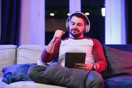 Front view of positive friendly joyful 30-aged guy with well-maintained beard which enjoying cool...
