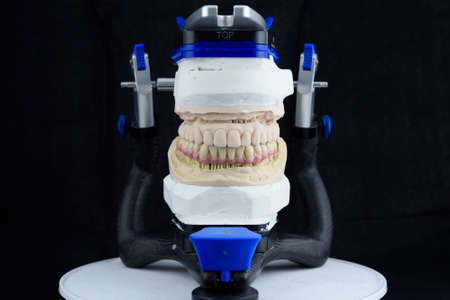 Dental technician working with articulator in dental labの写真素材