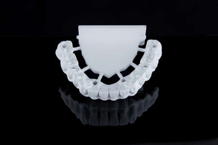 Milled raw zircon dental prosthesis for patient after milling machine, lower jaw.