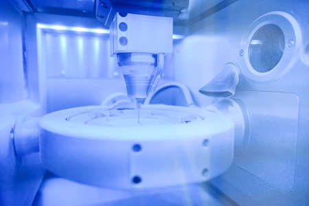 Cad cam milling machine in dental laboratory. Production of high esthetic dental crowns and dentures.の写真素材