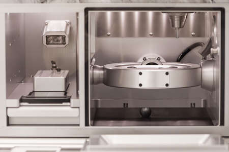 Cad cam milling machine in dental laboratory. Production of high esthetic dental crowns and dentures.の写真素材
