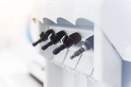 Dental handpieces cleans and lubricates on a special machine. Professional equipment care.の写真素材