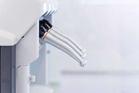 Dental handpieces cleans and lubricates on a special machine. Professional equipment care.の写真素材