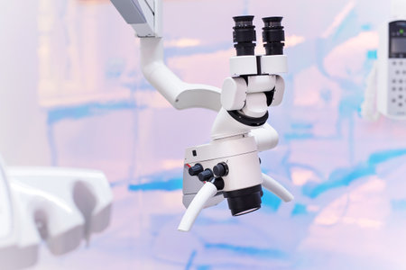 Dental binocular microscope on the background of modern dental clinic. Professional medical equipment.の写真素材