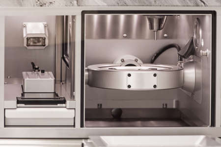 Cad cam milling machine in dental laboratory. Production of high esthetic dental crowns and dentures.の写真素材