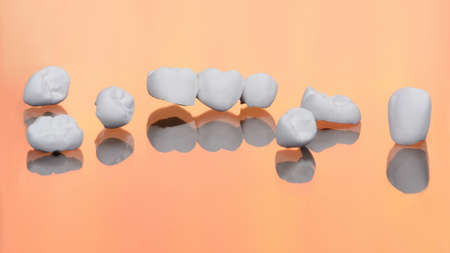 High aesthetic zirconia dentures and crowns on colorful background. Set of single dentures and...