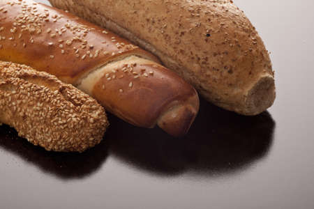 Assorted freshly baked bread with a gourmet sesame coated baguette, wholewheat roll and golden...
