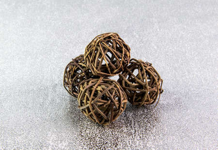 Decorative wicker wooden balls on a silver background.の写真素材