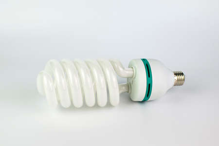 Energy saving light bulb with green line on a white background