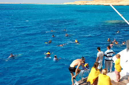 AL-MAHMYA ISLAND, EGYPT - OCTOBER 17, 2013: Unidentified people swim in the Red Sea near the island Al-Mahmya, Egyptのeditorial素材