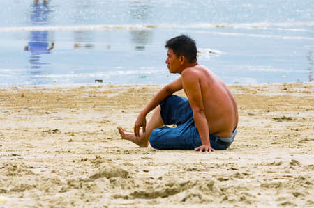 Vung Tau, Vietnam - January 30, 2018:Vietnamese man is resting on the beachのeditorial素材