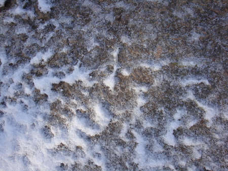 Industrial structure of concrete and bricks. Snow and leaks of melt water. Brown tones.の写真素材