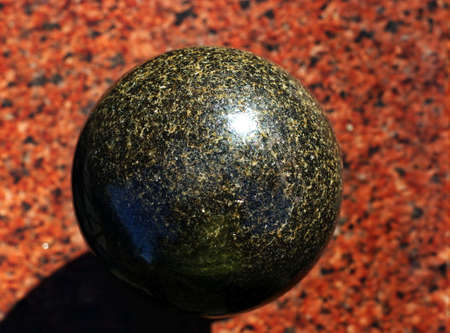 Granite stone polished ball on a granite slab Multi-coloredの写真素材