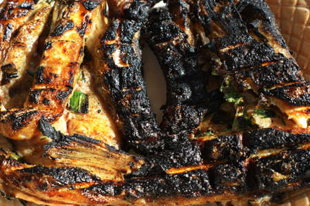 Barbecue bonfire fish. Fried fish grilled on the dying embers in the open air. Concept of summer...