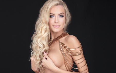 Sensual blonde beautiful lady posing . Woman with ideal body. Studio shot.の写真素材