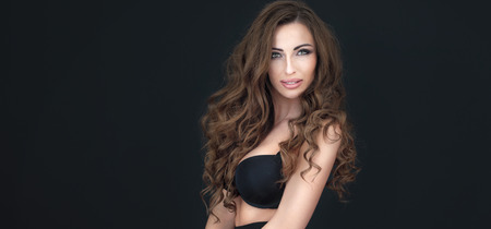 Sexy attractive brunette woman posing, looking at camera.の写真素材