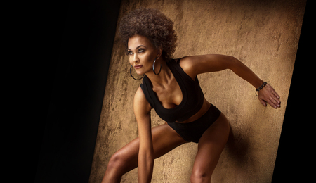Fashionable attractive african american woman with afro hairstyle posing.の写真素材