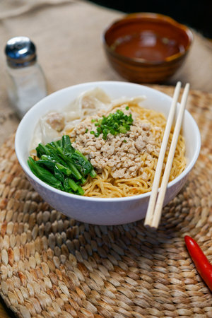 Rice noodle with minced pork and vegetable in bowl on tableの写真素材