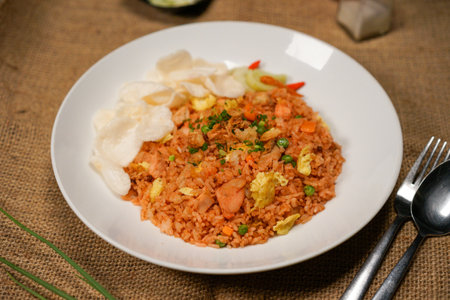 Fried rice with shrimps and vegetables on a white plateの写真素材