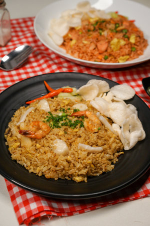 Fried rice with prawns and dumplings on plateの写真素材