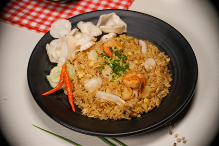 Fried rice with shrimp in black plate on white table background.の写真素材
