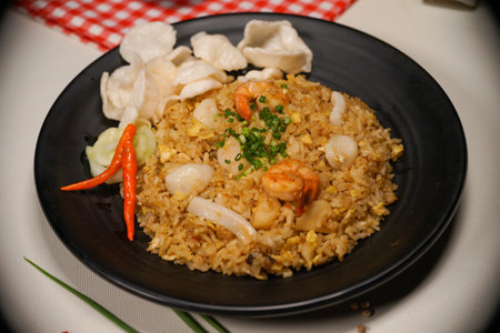 Fried rice with shrimps and prawns in black plateの写真素材