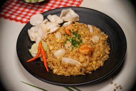 Fried rice with shrimp and vegetables on black plate, Thai foodの写真素材