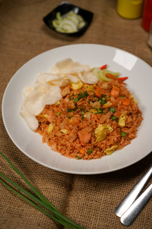 Fried rice with pork and vegetables on a plate, Thai styleの写真素材
