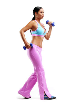 Young woman doing fitness exercise with hand weights on white backgroundの写真素材