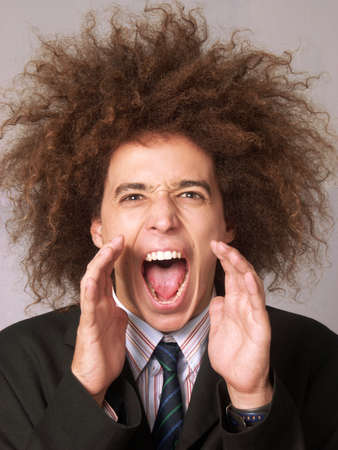Businessman with afro hairstyle shoutingの写真素材