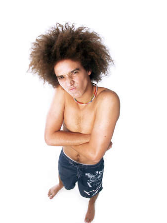Young shirtless man with afro hairstyle and arms folded on white backgroundの写真素材
