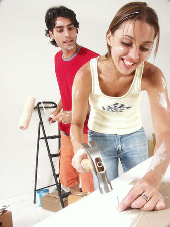 Hispanic couple working on their new home togetherの写真素材