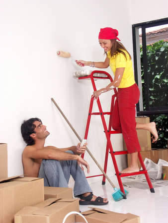 Hispanic couple working on their new home togetherの写真素材
