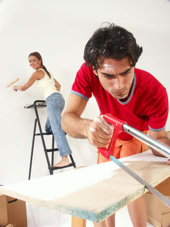 Hispanic couple working on their new home togetherの写真素材