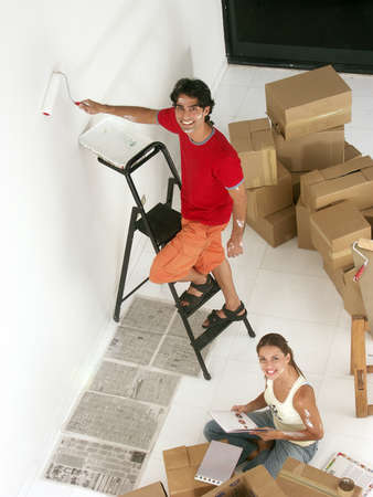Hispanic couple working on their new home togetherの写真素材