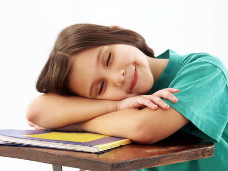 Little school girl on her deskの写真素材