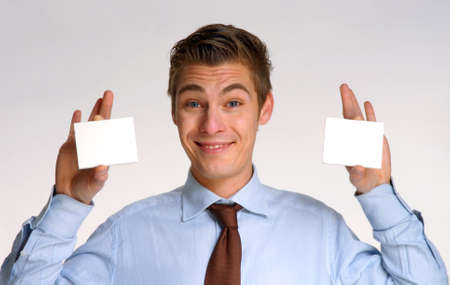 Young businessman holding business cards