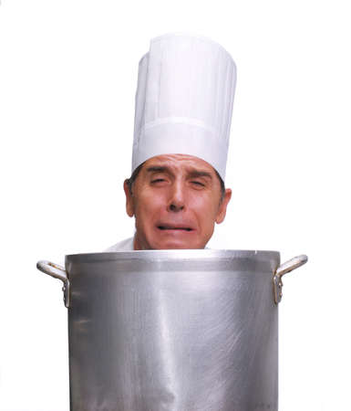 Cook looking upset behind a large pot on white backgroundの写真素材