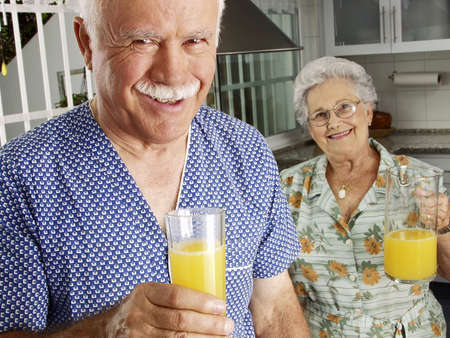 An elderly couple having breakfast in the kitchen