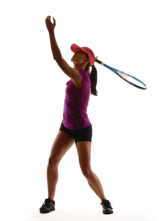 Young woman in gym attire holding a tennis racket on white backgroundの写真素材