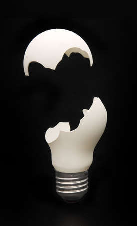 Broken light bulb on black background
