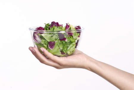 Human hand holding a bowl of salad の写真素材