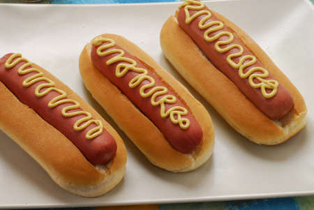 Hotdogs arranged neatly on a plateの写真素材