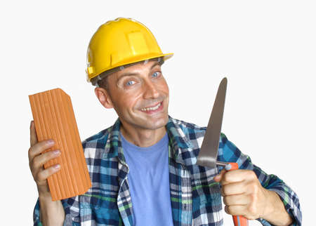 Construction worker holding a brick and a trowel