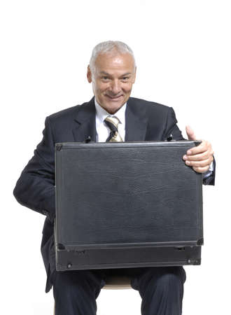 Senior man in suit with open briefcaseの写真素材