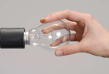 Hand attaching a light bulb